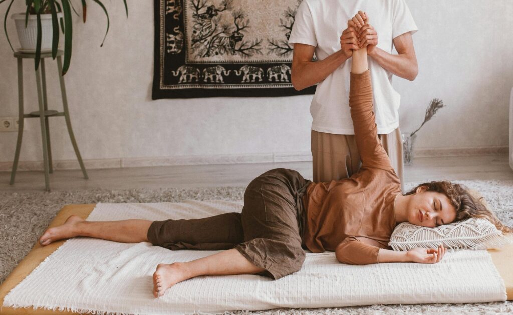 Man Crouching and Doing Massage to Woman